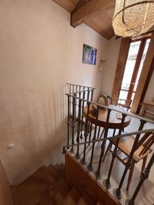 a room with a staircase with a table and chairs at Ánimas, elegantes pisos en el centro histórico in Pontevedra +9 photos