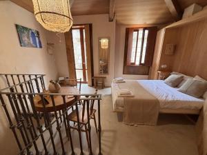 a bedroom with a bed and a table in it at Ánimas, elegantes pisos en el centro histórico in Pontevedra