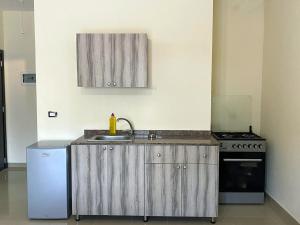 a kitchen with a sink and a stove at Chalet 101 - Zresidence - Faitroun in Al ‘Aqabah