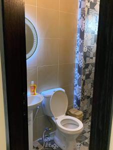 a bathroom with a toilet and a sink at Chalet 101 - Zresidence - Faitroun in Al ‘Aqabah