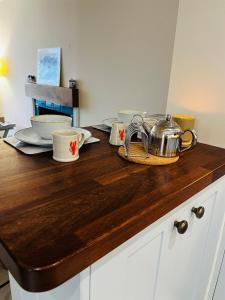 a kitchen counter with bowls and utensils on it at Angel Cottage, Strone in Dunoon