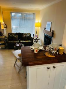 a kitchen and living room with a counter top at Angel Cottage, Strone in Dunoon
