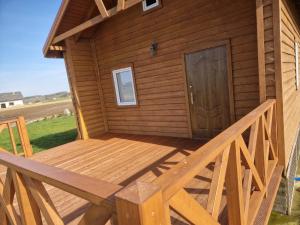 a outside deck of a cabin with a door at Domek u Stasia in Połęczyno