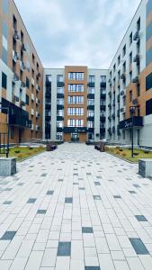 an empty parking lot in front of some buildings at Новая Евродвушка&Комфорт КЖБИ in Kostanay