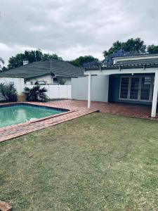 a house with a swimming pool in the yard at Eagles Enest BnB in Pietermaritzburg