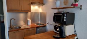 a kitchen with a coffee machine on a counter at Appartement rénové in Campan