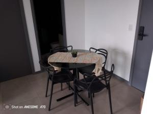 a dining room table with chairs and a table and a table and chairs at Ap Praia do Frances in Marechal Deodoro