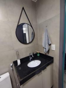 a bathroom with a sink and a mirror at Ap Praia do Frances in Marechal Deodoro