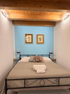 a bedroom with a large bed with two towels on it at Tanto di Cappello Home in Palermo