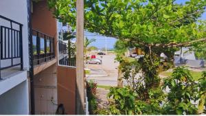 a view of a street from a balcony of a building at Suite Bouganville in Matinhos