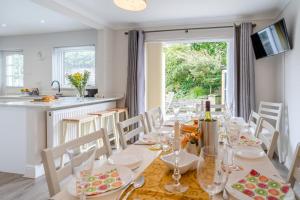a dining room with a table and chairs and a kitchen at 5 Bed in Oxwich oc-g31916 in Oxwich