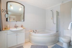 a bathroom with a tub and a sink and a toilet at 5 Bed in Oxwich oc-g31916 in Oxwich +30 photos