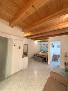 a living room with a bed and a wooden ceiling at Tanto di Cappello Home in Palermo