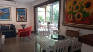 a living room with a table and chairs and a couch at Itacimirim Beach House in Camacari