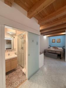 a large bathroom with a shower and a bed at Tanto di Cappello Home in Palermo +20 photos