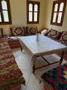 a living room with a table with a candle on it at Auberge Ighounba in Tinerhir