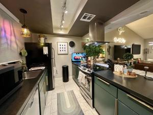 a kitchen with black counter tops and a kitchen with a sink at Spacious 1 BR villa on golf course with epic views! in Palm Desert