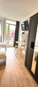 a room with a door open to a room with a table at Business Apartment with Balcony in Osnabrück