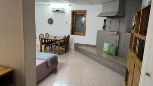 a kitchen with a table and a dining room at casa vacanza con terrazza secondo piano in Laterza