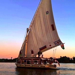two people on a sail boat on the water at Katadool Boat in Aswan