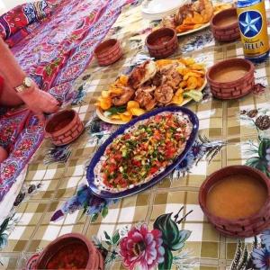 a table with a plate of food on a table at Katadool Boat in Aswan