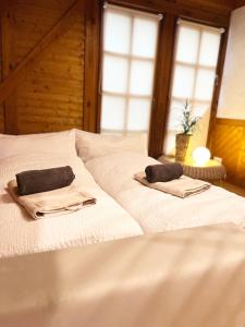 a white bed with two pillows on top of it at Hundertwasser Hideaway - Villa am Wald bei Bamberg 