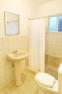 a bathroom with a sink and a toilet and a shower at Bright & Spacious Apartment Room - Santo Domingo Este in Cancino