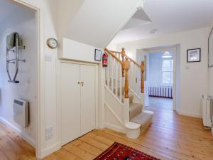 a hallway with white walls and stairs in a home at 3 bed in Achnasheen CA120 in Inveralligin +62 photos