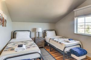 two twin beds in a room with a window at The View at Mountain Retreat By Red Rocks and Golden in Evergreen