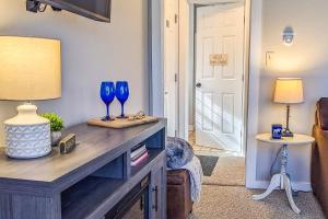 a living room with a table with two blue glasses on it at Cozy Ludlow Escape in Ludlow