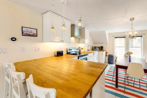 a kitchen with a large wooden table and white cabinets at Seatoller Unit C in Ludlow