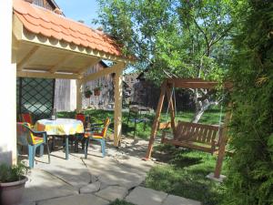a patio with a table and a swing at Apartments Ľubka in Zuberec