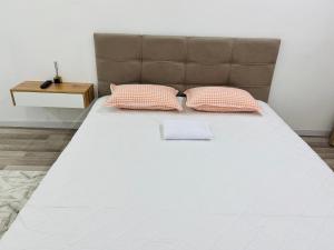 a large white bed with two pillows on it at Каратал 6Б in Taldykorgan +6 photos