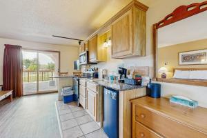 a kitchen with wooden cabinets and a counter top at Chula Vista Resort Villa # 7212 in Wisconsin Dells