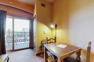 a dining room with a table and a balcony at Chula Vista Resort Condo # 2520 in Wisconsin Dells