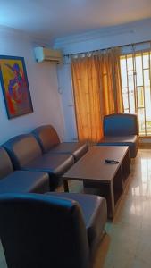a living room with couches and a coffee table at Royale Signature in Lagos