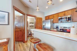 a kitchen with wooden cabinets and a counter top at Los Pinos #D10 in Breckenridge +12 photos