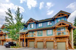 a blue house with a car parked in front of it at Los Pinos #D10 in Breckenridge