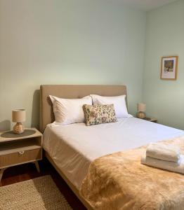 a bedroom with a bed with a pillow on it at Chimpanzee Forest House in Karpenision