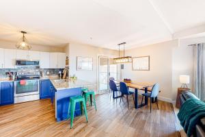 a kitchen and dining room with a table and chairs at Hilltop Hideaway - Legacy 401AB in Big White