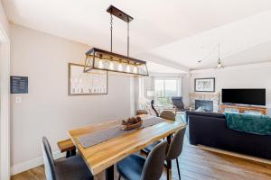 a dining room and living room with a table and chairs at Hilltop Hideaway - Legacy 401AB in Big White