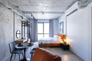 a bedroom with a bed and a table and chairs at C Living 3 - Al Malqa in Riyadh
