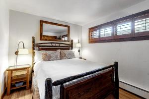 a bedroom with a bed and a mirror on the wall at 613 Tamarack in Moose Wilson Road