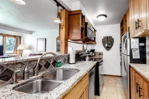 a kitchen with a sink and a stove at 613 Tamarack in Moose Wilson Road