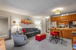 a living room with a couch and a kitchen at Grandview Condo in Breckenridge
