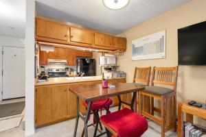 a small kitchen with a wooden table and chairs at Grandview Condo in Breckenridge