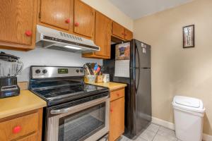 a kitchen with a stove and a refrigerator at Grandview Condo in Breckenridge +24 photos