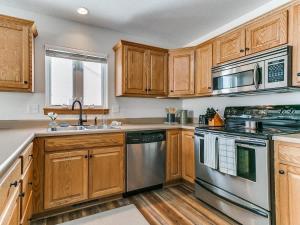 a kitchen with wooden cabinets and stainless steel appliances at 4901 Waller in Ames