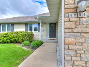 a house with a stone wall and a driveway at 4901 Waller in Ames