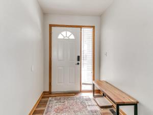 a hallway with a wooden bench and a door at 4901 Waller in Ames